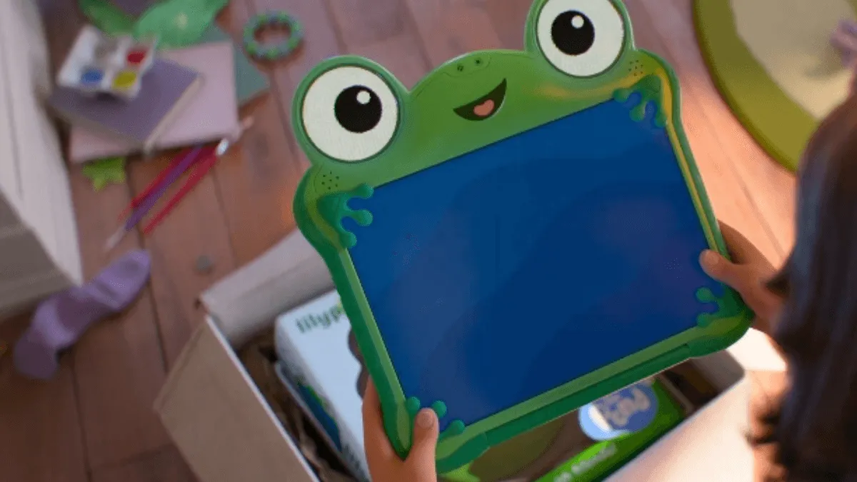 menina segurando um tablet verde que tem um sorriso