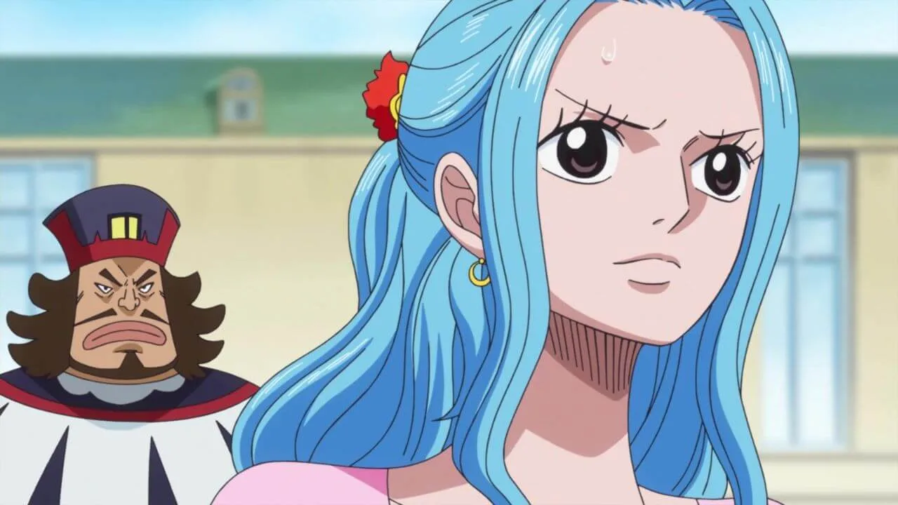 vivi usando uma roupa rosa e aparentemente preocupa e próximo a ela está um homem barbado com cabelos grandes, roupa e chapéu nas cores azul, branco e vermelho